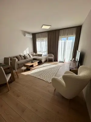 a living room with a couch and a table at Apart-Hotel Crown Bansko 2 in Bansko
