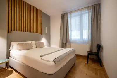 a bedroom with a large bed and a window at Luxury room 12-3 in Plovdiv