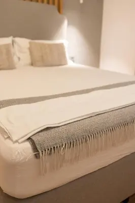 a bed with white sheets and pillows on it at Luxury room 12-3 in Plovdiv