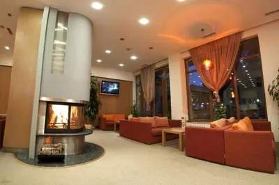 a living room with couches and a fire place at Studio Villa Park 325 in Borovets