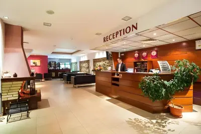 a man standing at the reception desk of a restaurant at Studio Elegance Pamporovo in Pamporovo