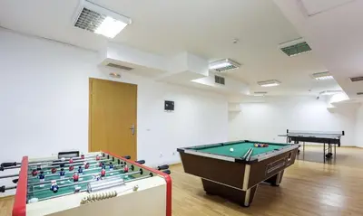a room with a pool table and two tables at Studio Elegance Pamporovo in Pamporovo