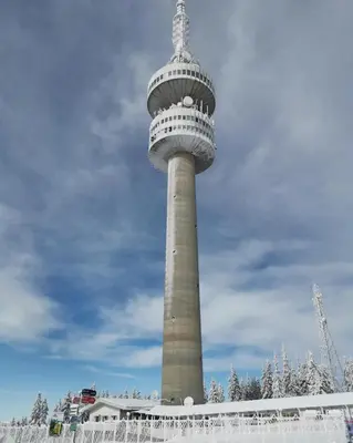 a tall tower with a balcony on top of it at Студио Ая- Смолянски езера in Smolyan