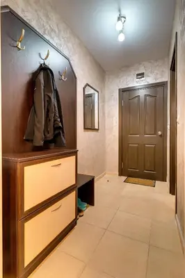 a hallway with a wooden door and aabinet at Студио Ая- Смолянски езера in Smolyan
