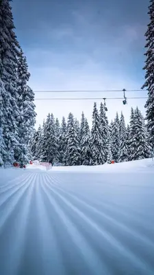 a snow covered road with a ski lift at Студио Ая- Смолянски езера in Smolyan