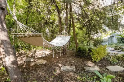 a hammock hanging from a tree in a yard at Sophisticated Gem in the Heart of Sofia in Sofia
