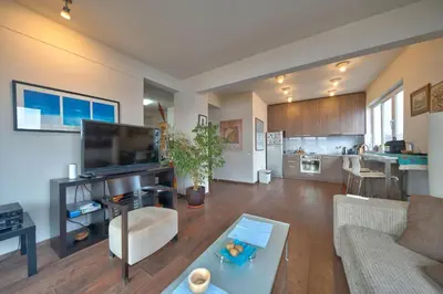 a living room with a couch a table and a kitchen at Sofia center best view by Flat Mаnager in Sofia
