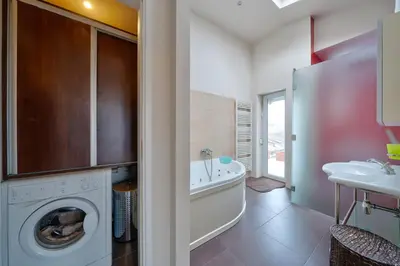 a bathroom with a washing machine and a sink at Sofia center best view by Flat Mаnager in Sofia