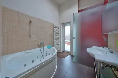 a bathroom with a white tub and a sink at Sofia center best view by Flat Mаnager in Sofia