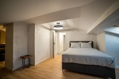 a bedroom with a large bed in a room at ARHEYA 8 apart/АРХЕЯ 8 апартамент за гости in Karlovo