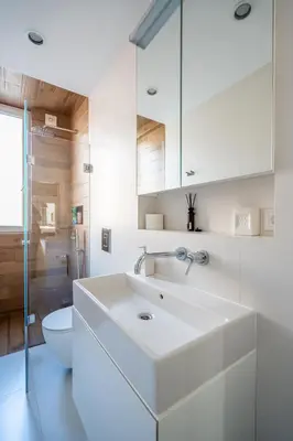 a white bathroom with a sink and a toilet at Elegant Getaway Near Iconic Eagles' Bridge in Sofia