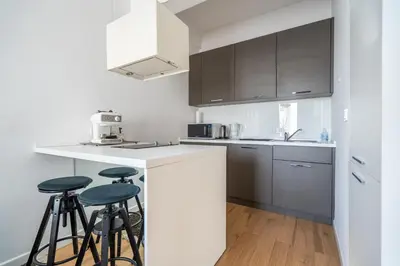 a kitchen with two bar stools and a counter top at Elegant Getaway Near Iconic Eagles' Bridge in Sofia