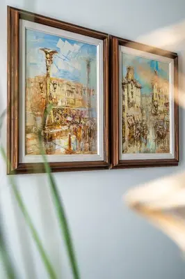 two framed paintings on a wall at Elegant Getaway Near Iconic Eagles' Bridge in Sofia