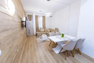 a living room with a white table and chairs at Bellalux in Sandanski