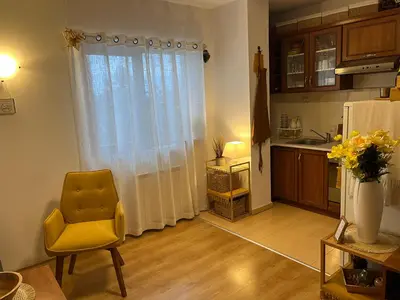 a kitchen with a yellow chair and a window at Boro Hills in Borovets
