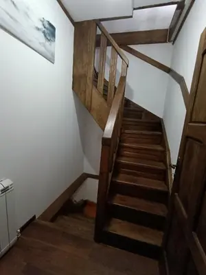 a staircase in a house with wooden steps at Detached Guest House Рилски кът Маджаре in Madzhare