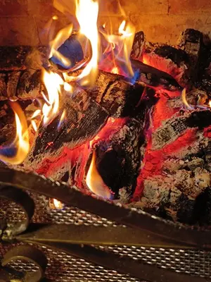 a fire in a brick oven with flames at Detached Guest House Рилски кът Маджаре in Madzhare