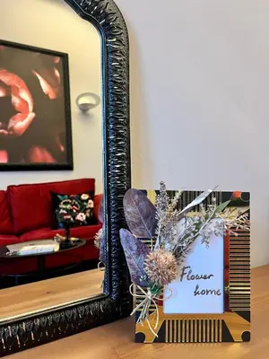 a mirror and a vase with flowers in a living room at Flower house 9 in Sofia