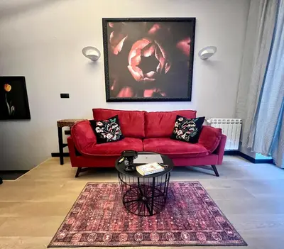 a living room with a red couch and a table at Flower house 9 in Sofia