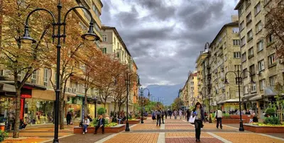 a group of people walking down a city street at Cappuccino apartment in Sofia