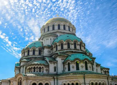 a large building with a domed building with a sky at Cappuccino apartment in Sofia