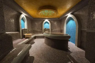 a bathroom with a toilet and a sink and windows at Paradise SPA Hotel in Tsigov Chark