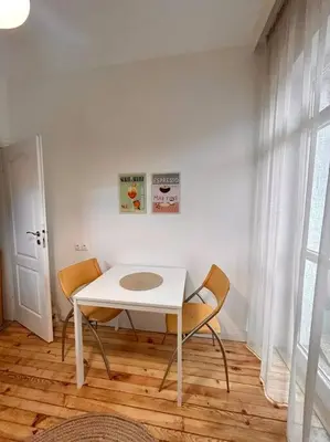 a white table and two chairs in a room at Chic Urban Retreat in Sofia