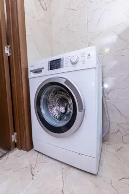 a white washing machine sitting in a bathroom at Topalov in Sandanski