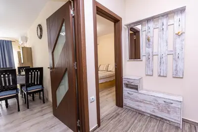 an open door to a room with a table and chairs at Topalov in Sandanski