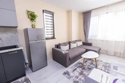 a small living room with a couch and a refrigerator at Apartment Betty in Sandanski