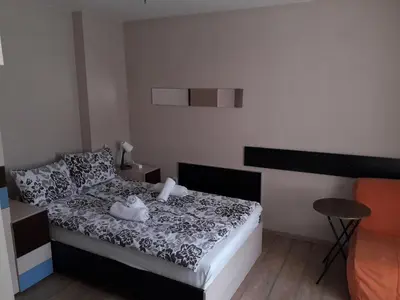 a small bedroom with a bed and a table at Studio V Plovdiv in Plovdiv
