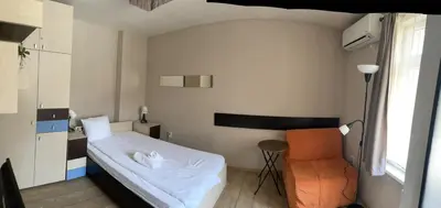 a small room with a bed and a chair at Studio V Plovdiv in Plovdiv
