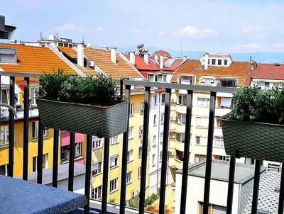 three potted plants on the balcony of a building at Sky Apartments in Blagoevgrad