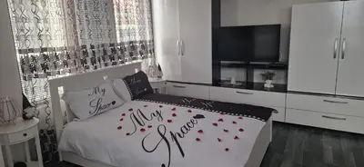 a bedroom with a bed with red hearts on it at Black and White Apartment in Karlovo