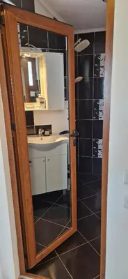 a bathroom with a sink and a mirror at Black and White Apartment in Karlovo