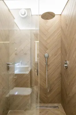 a shower with a glass door and a sink at SOFapart Boutique Apartments in Sofia