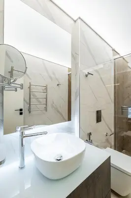 a white bathroom with a sink and a shower at SOFapart Boutique Apartments in Sofia