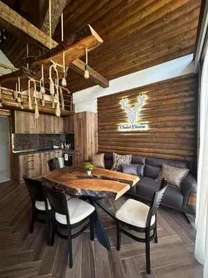 a dining room with a table and chairs at CHALET ELEVEN in Dospat