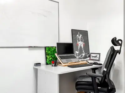 a desk with a laptop and a chair on it at Doynov's Apartment in Sofia