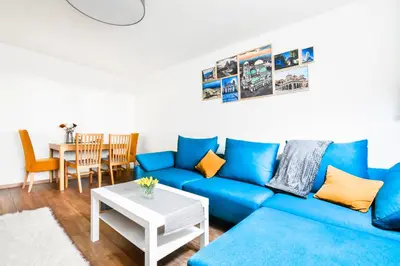 a living room with a blue couch and a table at Doynov's Apartment in Sofia