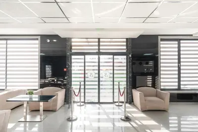 a lobby with chairs and a table and windows at Hotel Boutique 5 - Free parking - Free breakfast - Free internet - EVSE in Sofia