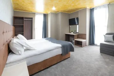 a bedroom with a large bed and a television at Hotel Boutique 5 - Free parking - Free breakfast - Free internet - EVSE in Sofia