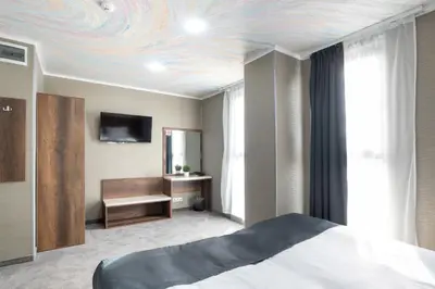 a bedroom with a bed and a tv on a ceiling at Hotel Boutique 5 - Free parking - Free breakfast - Free internet - EVSE in Sofia