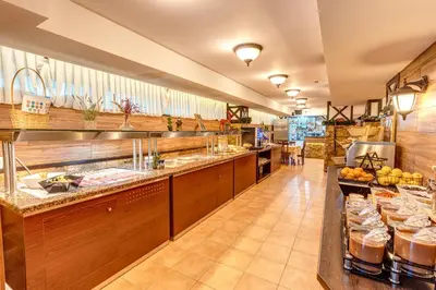 a large kitchen with a buffet line in a restaurant at Dream View Apartments in Pamporovo