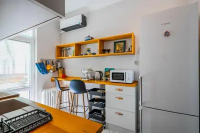 a kitchen with a counter and a refrigerator at Cozy Heaven at Vitosha Blvd - Sofia - 2BDR in Sofia