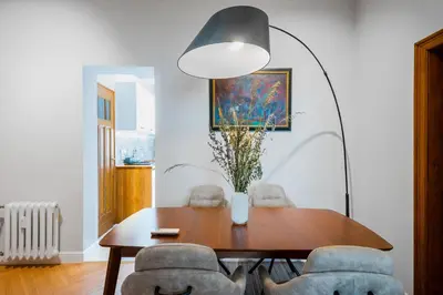 a dining room with a wooden table and chairs at Cozy Heaven at Vitosha Blvd - Sofia - 2BDR in Sofia