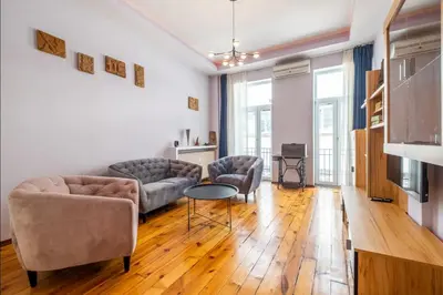 a living room with two couches and a table at Charming 2BDR Apartment in Historic Center With Parking in Sofia