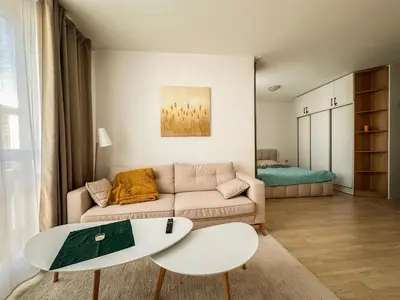 a living room with a couch and a table at Bansko Ski Resort Apartment 2-3 people in Bansko