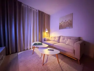 a living room with a couch and a table at Bansko Ski Resort Apartment 2-3 people in Bansko