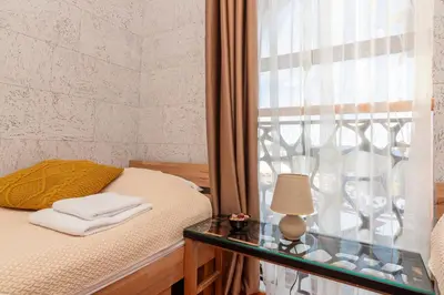 a bedroom with a bed and a glass table with a lamp at The Golden Nest - 3 Bedroom Family Mountain Apartment in Pamporovo